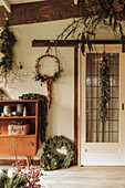 Entrance area decorated for Christmas with wreaths and fir garland