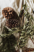 Pine cones and olive branches on linen cloth