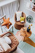 Playroom with rattan armchairs, colourful carpet and child-friendly decorations