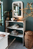 Shabby chic bathroom shelf with towels, mirror and illuminated star