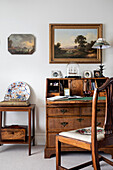 Antique mahogany desk with memorabilia and wall paintings