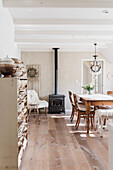 Country-style dining room with wood-burning stove and chandelier