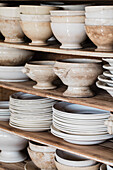 Shelves with vintage ceramic crockery in neutral tones