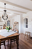 Country style dining room with wooden table and chandelier