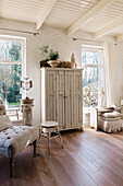 Bright living room with shabby chic cabinet and wooden floor