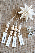 Name tag with wooden beads on jute fabric