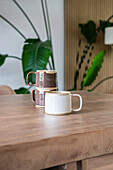 Ceramic cups on a solid wooden table