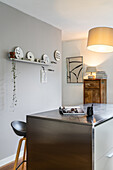 Kitchen with metal kitchen island and modern decoration made of wall plates