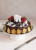 Chocolate cake with polar bear decoration and redcurrants