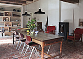 Dining room with rustic wooden table, fireplace and tiled floor