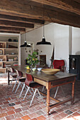 Rustic dining room with rustic wooden table and brick floor