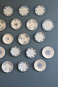 Porcelain plate collection arranged on a blue wall