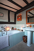 Rustic bathroom in a half-timbered house with atmospheric candlelight