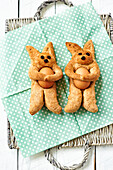 Baked Easter bunnies made from wholemeal flour with eggs on a dotted napkin