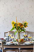 Table set with sunflowers and apples