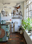 Country kitchen with rustic flair, terracotta tiles and wall shelf