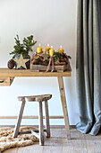 Wooden table with Advent decorations made from candles, pine cones and twigs