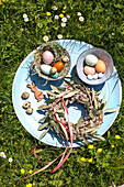 Easter decoration with eggs and wreath on a blue tray in spring