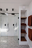 Modern bathroom with rain shower and terrazzo tiles