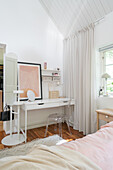 Bright bedroom with transparent acrylic chair and white dressing table