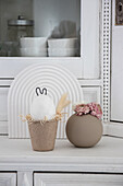 Country-style decoration: dried flowers and decorative bunny on kitchen buffet