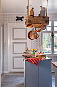 Country-style kitchen with wooden hanging shelves and spring decorations