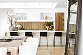 Bright cooking and dining area with wood and natural stone accents