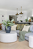 Modern eat-in kitchen with eucalyptus in an earthenware vase on a round table