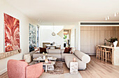 Modern living room with beige couch and marble tables