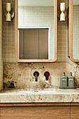 Marble washbasin with modern fittings and wooden framed mirror