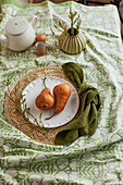 Pears on tablecloth with floral pattern