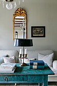 Antique coffee table in turquoise blue in front of a white sofa in the living room