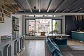 Open-plan living room with modern design, herringbone parquet flooring and large balcony