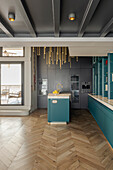 Open-plan kitchen with golden pendant lights in a modern design, herringbone parquet flooring