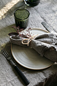 Rustic table setting with linen napkin and plant decoration