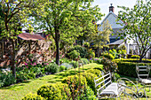 English garden with wrought-iron garden furniture in spring