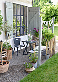Cosy terrace with self-made shutters and bamboo torches