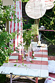 Painted beer garden set with stripes, DIY batik curtain, homemade candlesticks and lanterns