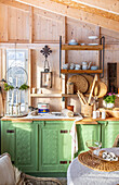 Country kitchen with green cabinet front and open shelves