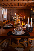 Rustic dining table with candle lighting and flower arrangement