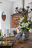Country-style table decoration with porcelain animal figurines and candlesticks