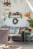 Sheltered terrace area with wicker furniture and spring decorations