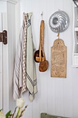Niche in a country house kitchen with wooden spoons, tea towels and baking tin