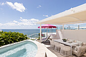 Terrace with sea view, whirlpool and dining area under a white pergola