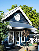 Blue café house with terrace and outdoor seating area