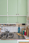 1940s-style kitchen with mint green cupboard doors
