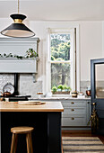 Traditional kitchen with light grey cabinets and wall tiles