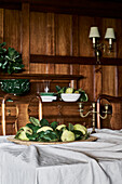 Table with pears and brass candlestick in rustic dining room