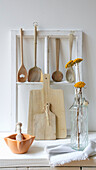 Rustic wooden kitchen accessories and dried flowers in a vase