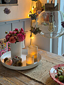 White tray with autumnal table decoration on a wooden table